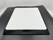 Black car hood with a white square patch on a gray background